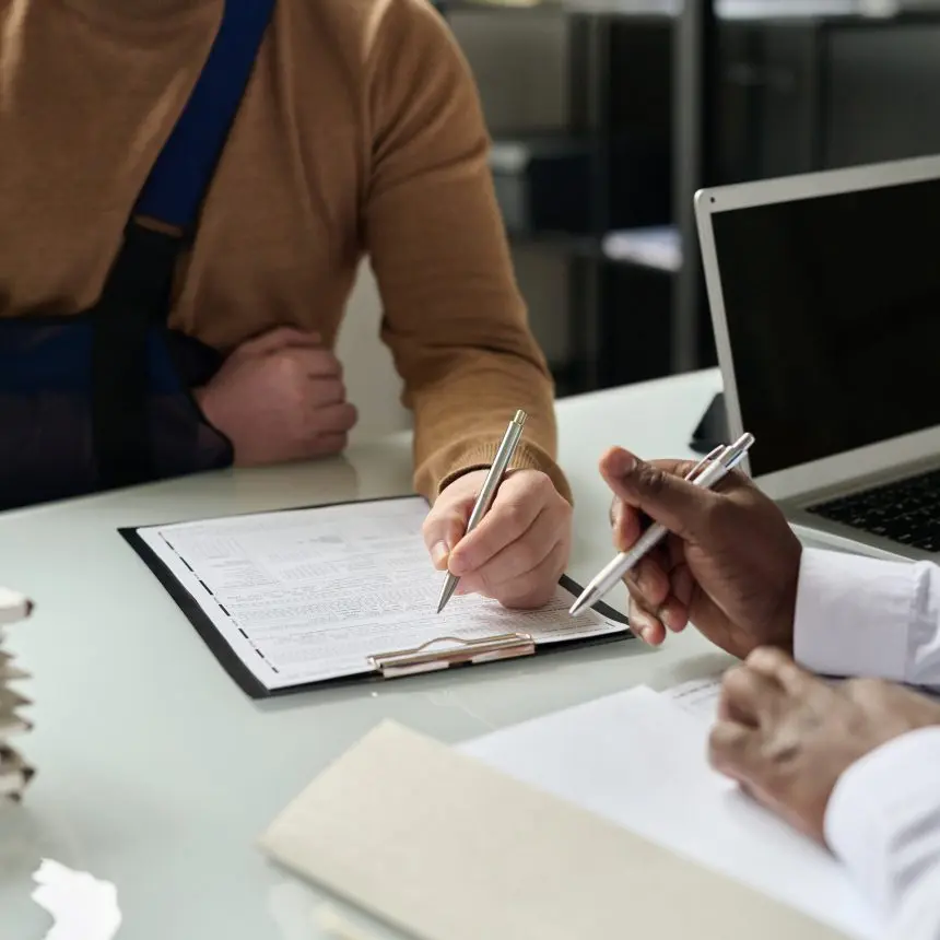 Person signing document with arm injury.