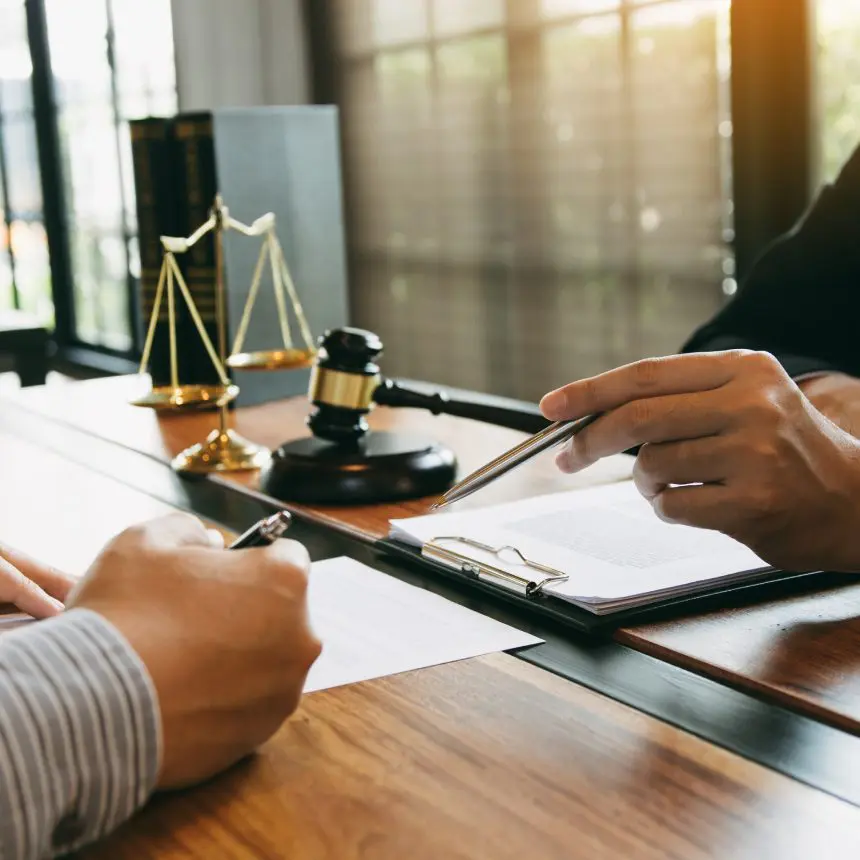 Lawyer and client reviewing legal documents.