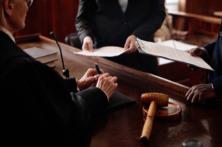 New Project (29) Judge signing legal documents in court.