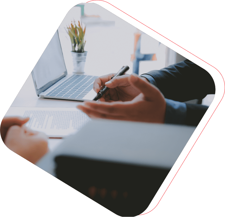 Business people reviewing documents at desk.